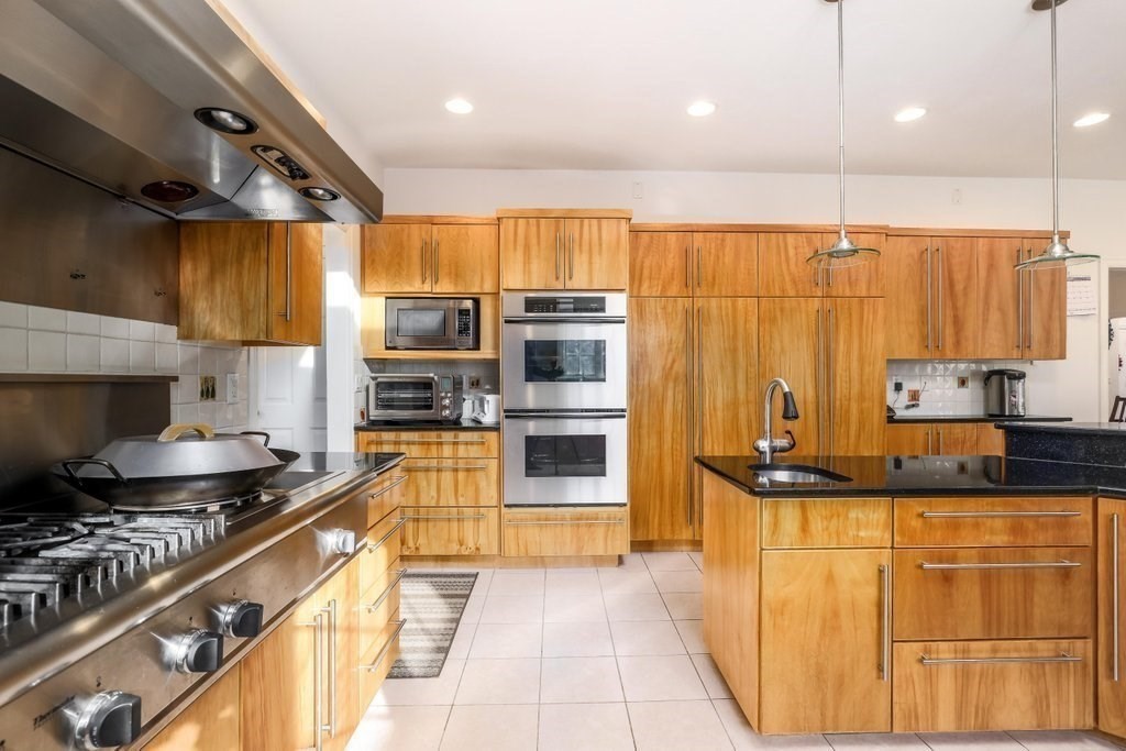 16 Steel Road Hopedale, MA 01747 - Photo 3 of 42 a kitchen with stainless steel appliances granite countertop a stove a sink and a refrigerator