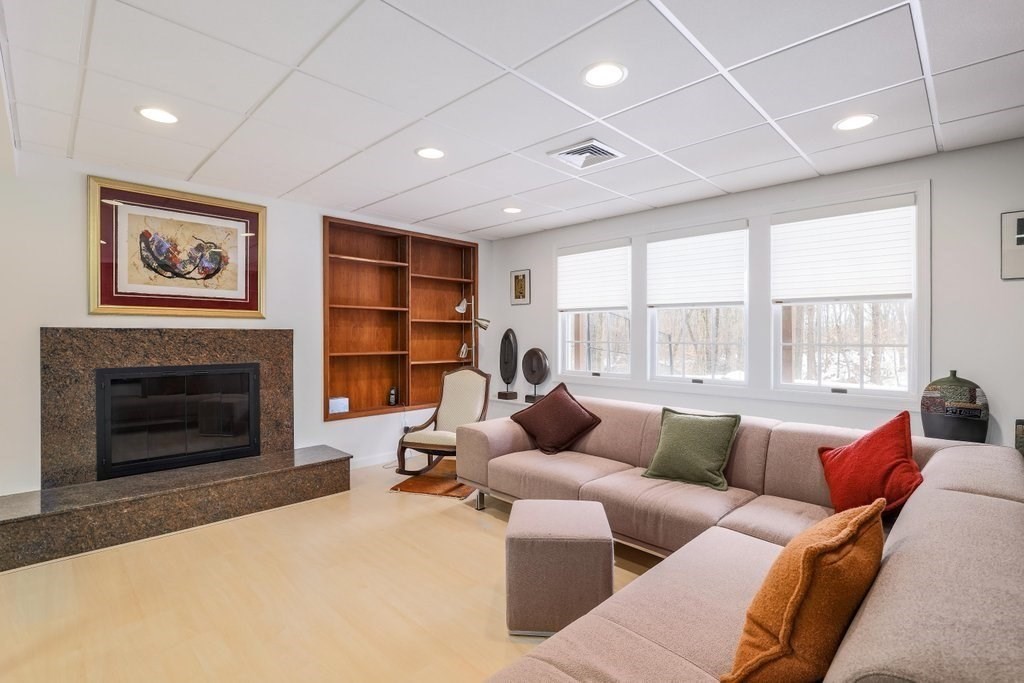 16 Steel Road Hopedale, MA 01747 - Photo 34 of 42 a living room with furniture a fireplace and a large window