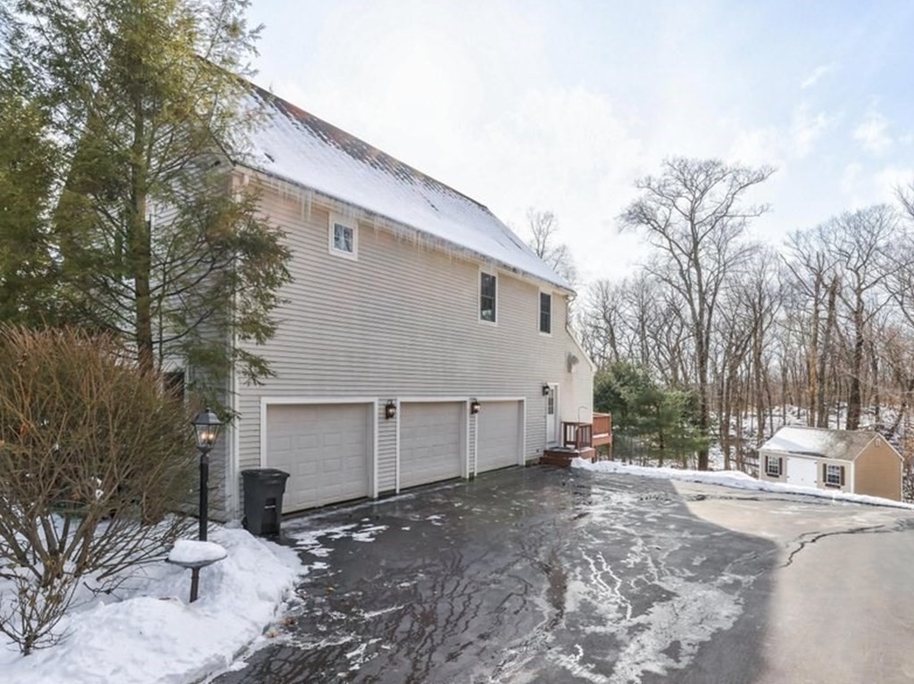 16 Steel Road Hopedale, MA 01747 - Photo 40 of 42 a view of a white house with a yard and covered with snow