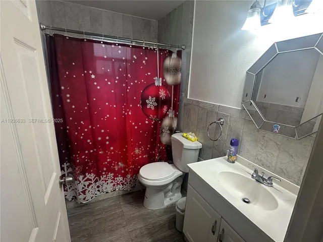 a bathroom with a sink toilet and mirror