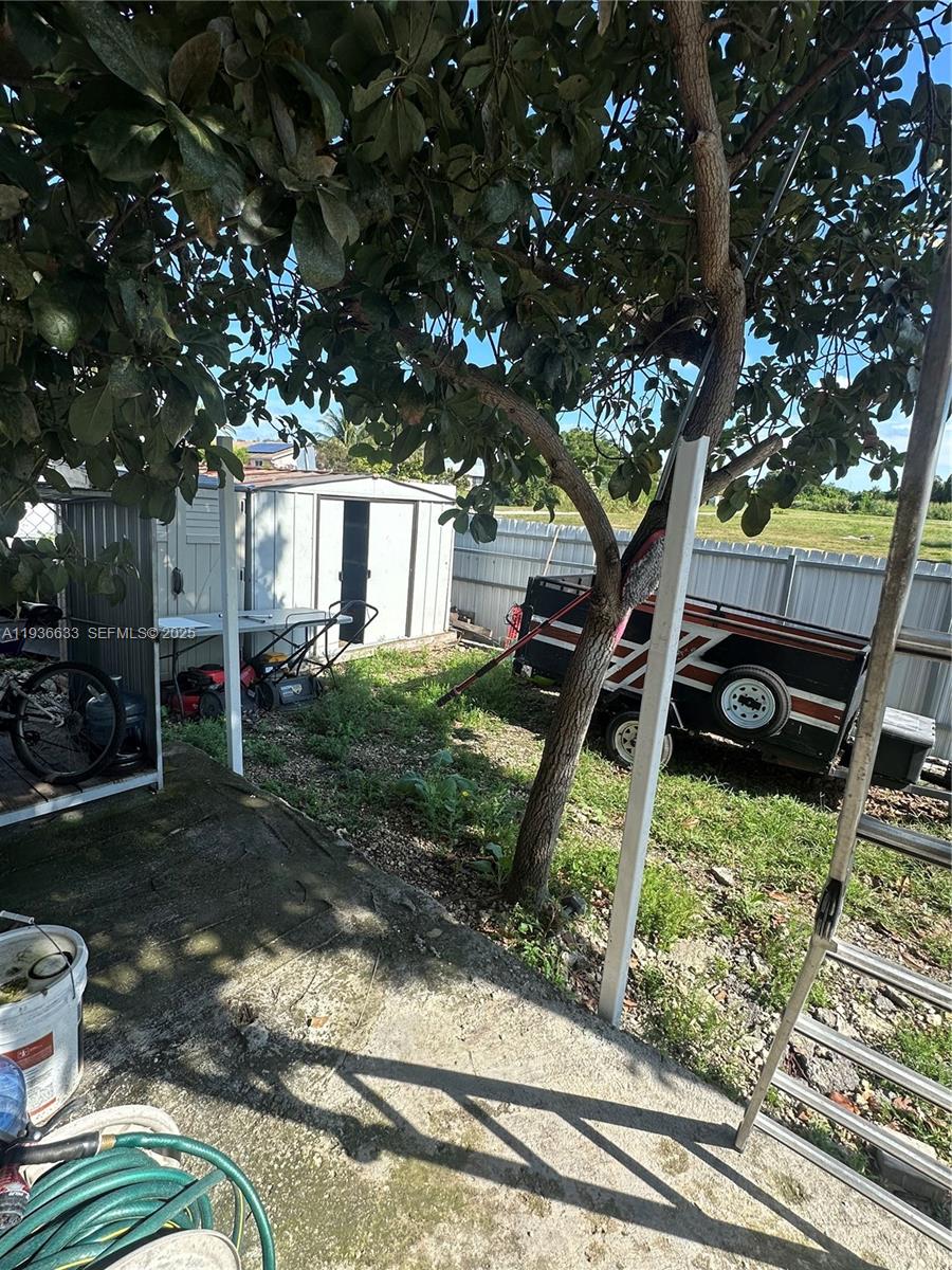 13200 Southwest 264th Street, Unit MAIN Homestead, FL 33032 - Photo 17 of 20 a front view of a house with a yard