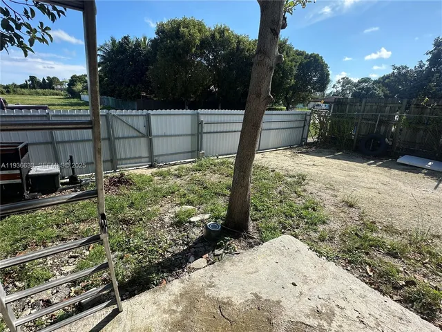 a view of a backyard of the house