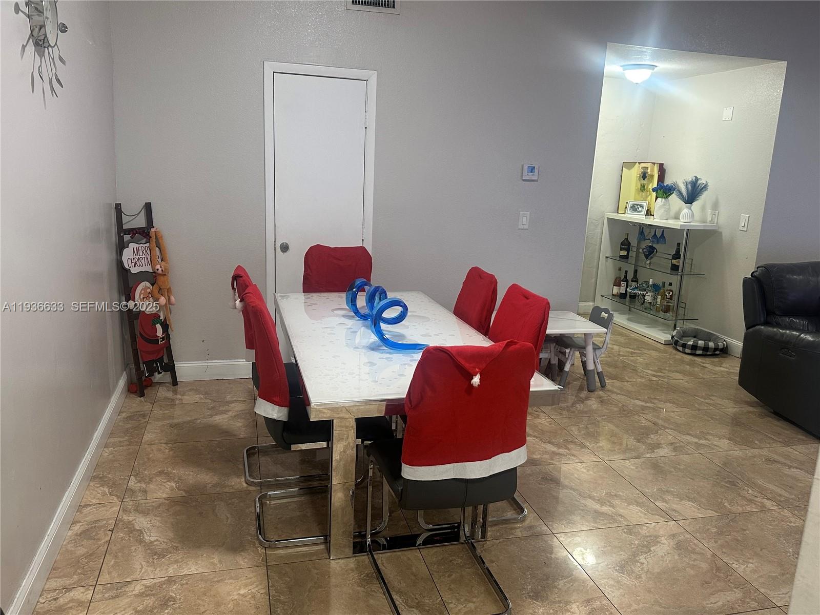 13200 Southwest 264th Street, Unit MAIN Homestead, FL 33032 - Photo 7 of 20 a view of a dining room with furniture