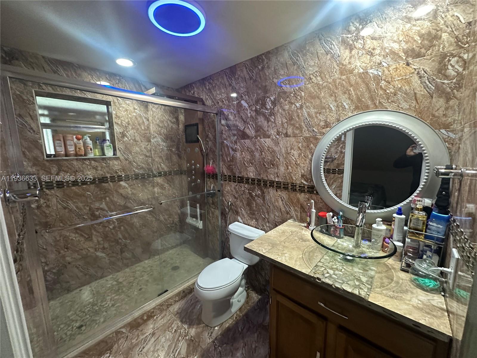 13200 Southwest 264th Street, Unit MAIN Homestead, FL 33032 - Photo 9 of 20 a bathroom with a toilet sink and mirror
