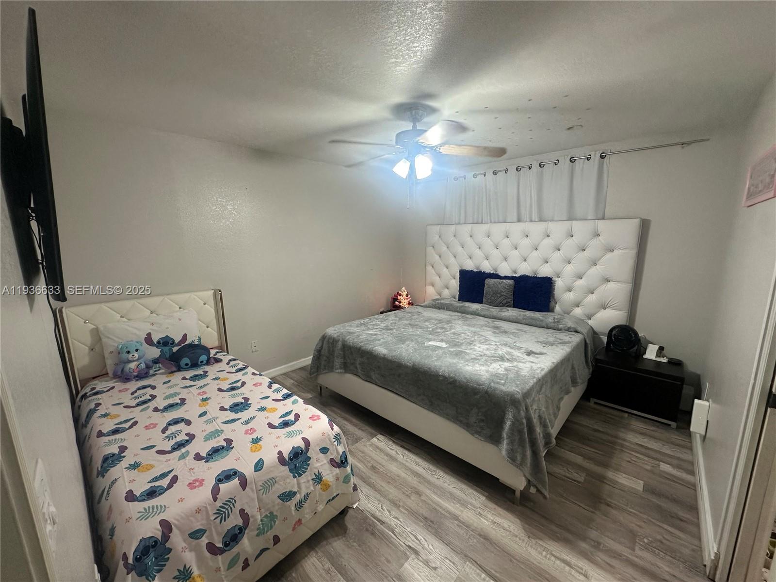 13200 Southwest 264th Street, Unit MAIN Homestead, FL 33032 - Photo 10 of 20 a bedroom with a bed and a mirror