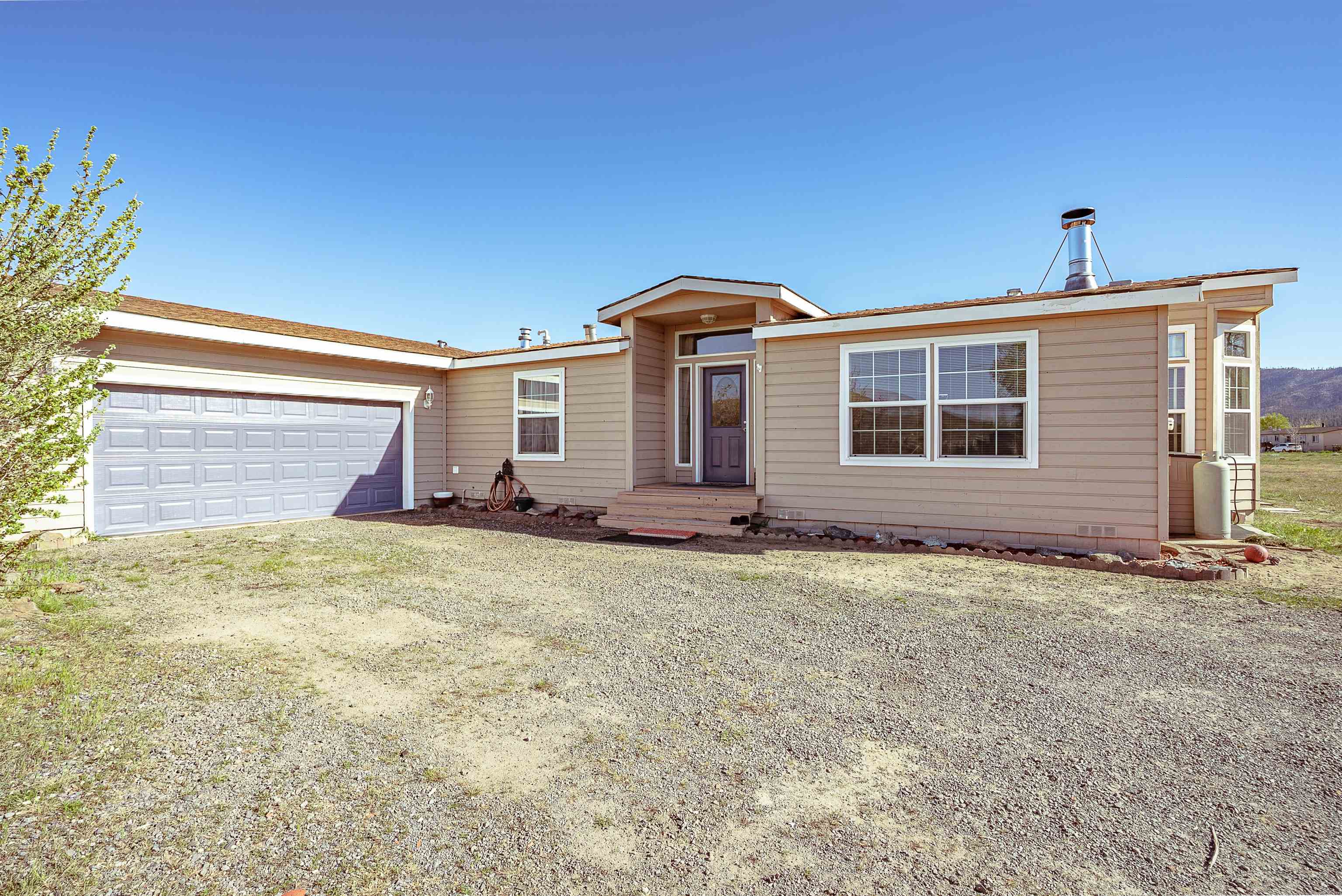 714-100 Sears Road Janesville, CA 96114 - Photo 1 of 35 a front view of a house with garden