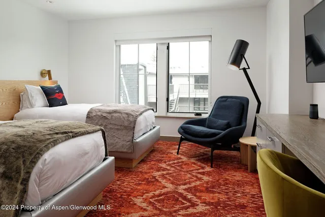 a living room with furniture a rug and a large window