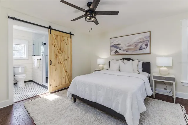 a bedroom with a bed and a painting on the wall