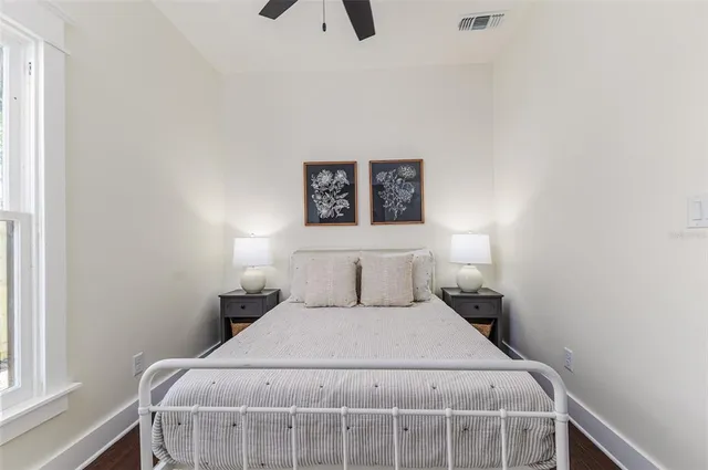 a bedroom with a bed and painting on the wall