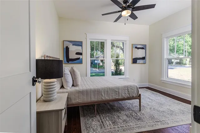 a bedroom with a bed and wooden floor