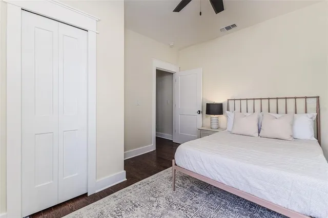 a bedroom with a bed and a rug