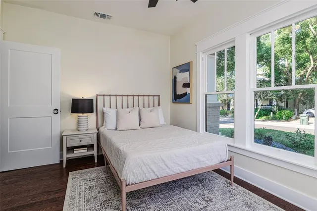 a bedroom with a bed and a large window