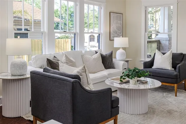 a living room with furniture and a large window