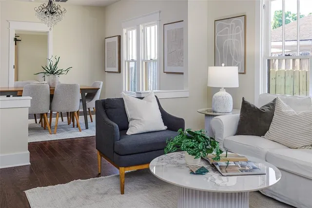 a living room with furniture and a wooden floor