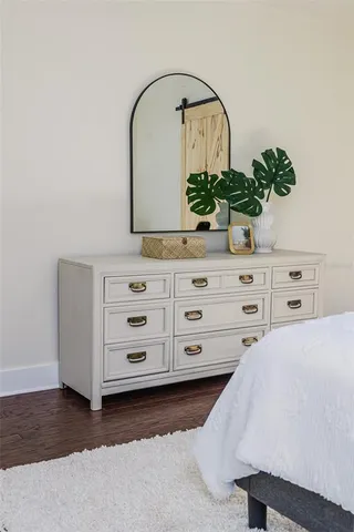 a bedroom with a bed and a potted plant