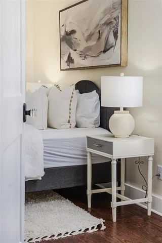 a bedroom with a bed and lamp