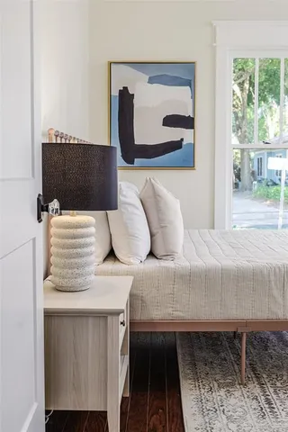 a bedroom with a bed and a mirror