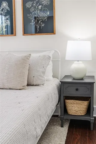 a bed sitting in a bedroom next to a lamp