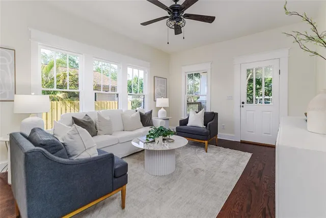 a living room with furniture potted plant and a window