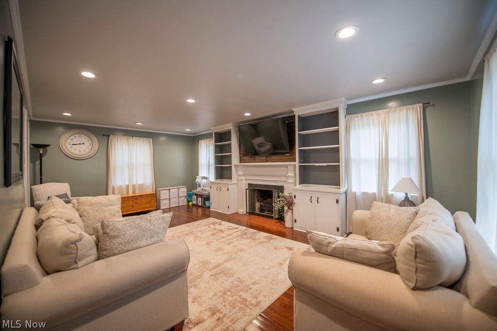 827 East 5th Street Dover, OH 44622 - Photo 9 of 38 Spacious living room featuring a cozy fireplace