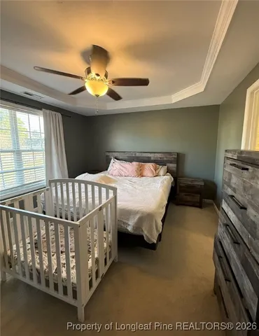 a bedroom with a bed and wooden floors