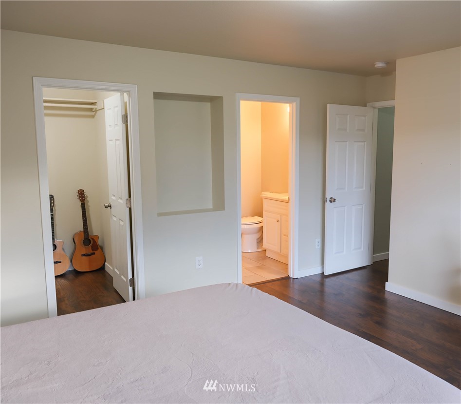 18041 Daryl Lane Southwest Rochester, WA 98579 - Photo 17 of 29 a bedroom with a bed and wooden floor