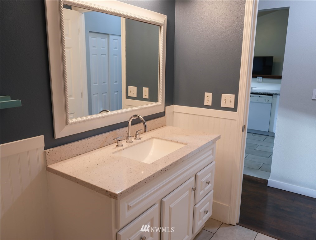 18041 Daryl Lane Southwest Rochester, WA 98579 - Photo 28 of 29 a bathroom with a sink and a mirror