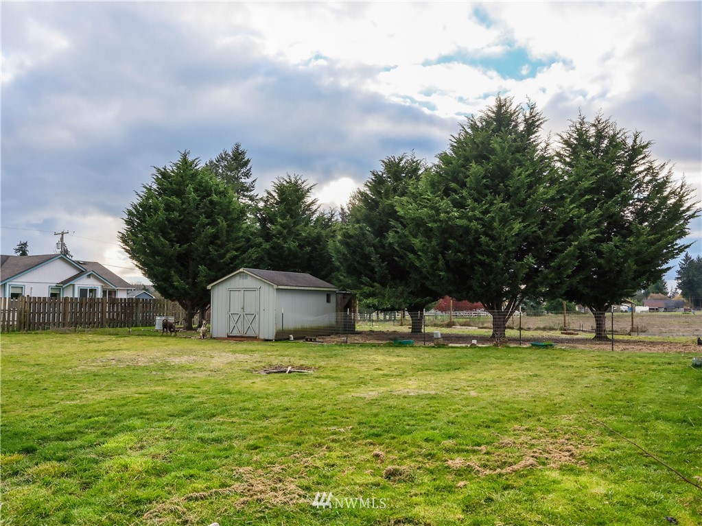 18041 Daryl Lane Southwest Rochester, WA 98579 - Photo 7 of 29 a white house with a big yard and large trees