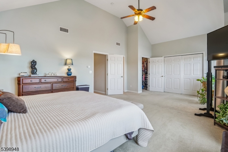 305 Kingsland Road Landing, NJ 07850 - Photo 21 of 40 a bedroom with a bed and a chandelier