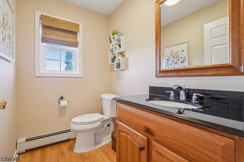 305 Kingsland Road Landing, NJ 07850 - Photo 4 of 40 a bathroom with a granite countertop sink a toilet and a mirror