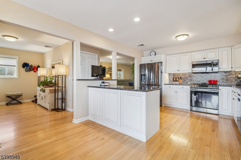 305 Kingsland Road Landing, NJ 07850 - Photo 6 of 40 a kitchen with stainless steel appliances granite countertop a refrigerator and a stove top oven