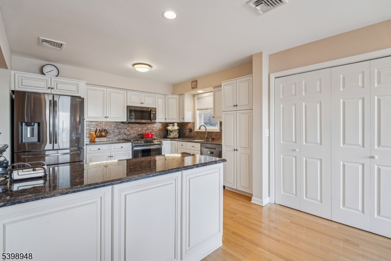 305 Kingsland Road Landing, NJ 07850 - Photo 7 of 40 a kitchen with stainless steel appliances a refrigerator sink and cabinets