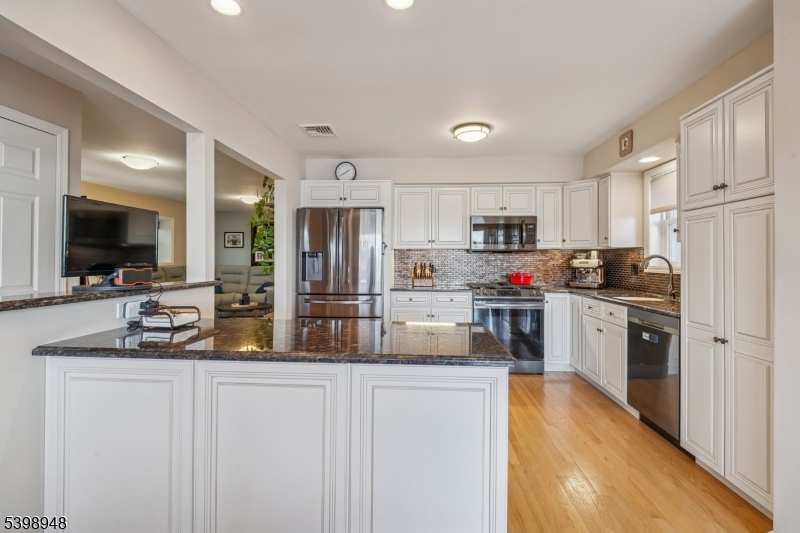 305 Kingsland Road Landing, NJ 07850 - Photo 10 of 40 a kitchen with refrigerator a microwave a stove and cabinets