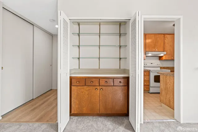 a view of a dining room with furniture a chandelier and a window