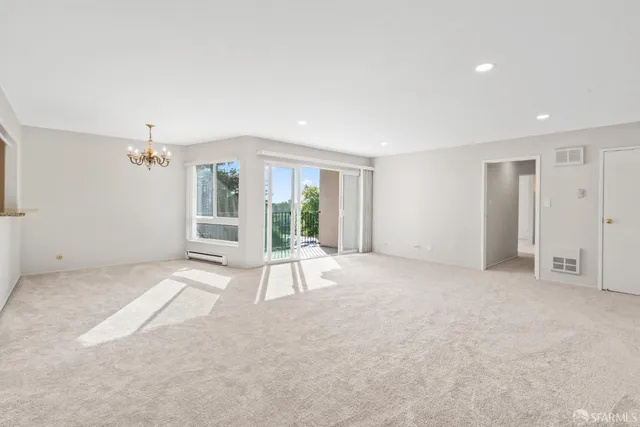 a view of a hallway with wooden floor and closet