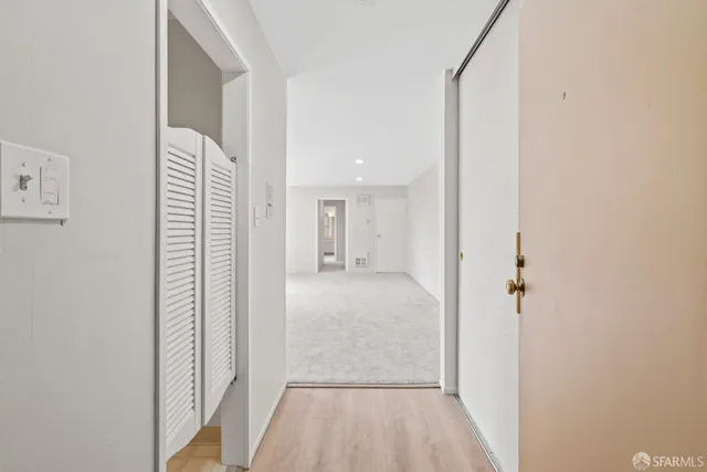 a view of a hallway with a bathroom