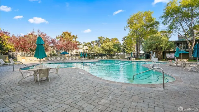 a front view of a house with a yard and lake view