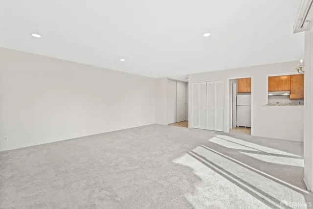 a bedroom with a bed and a potted plant on table