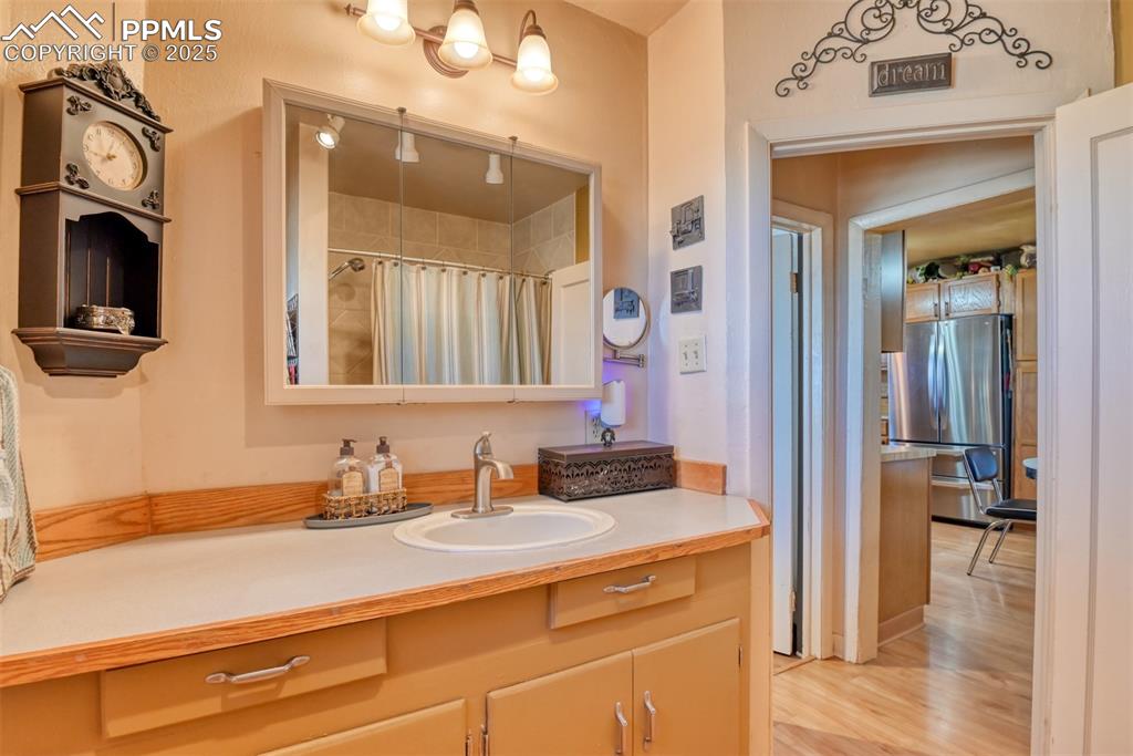 22500 Enoch Road Calhan, CO 80808 - Photo 12 of 50 a bathroom with a sink vanity and a mirror