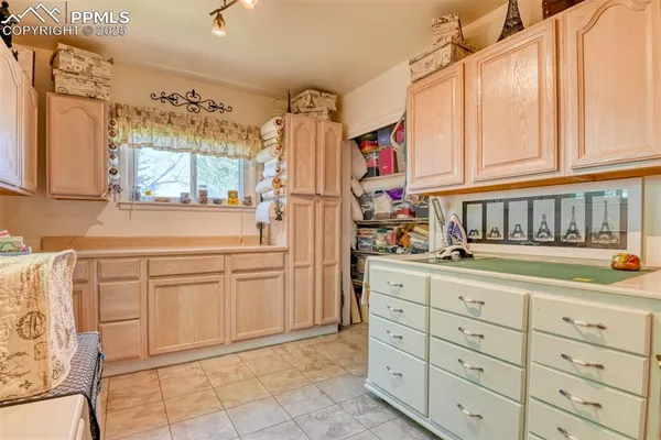 a kitchen with cabinets and window