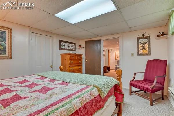 a bedroom with a bed and wooden furniture