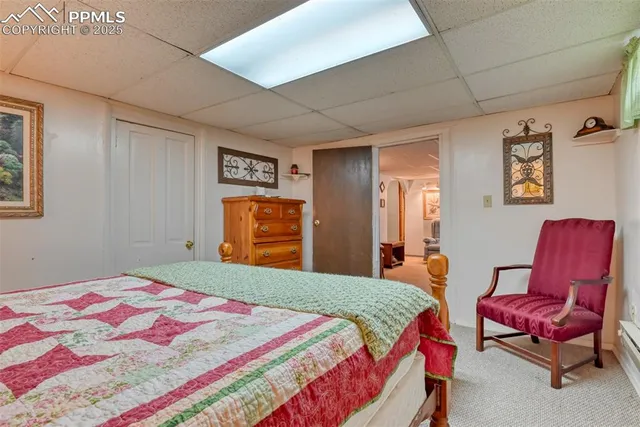 a bedroom with a bed and wooden furniture