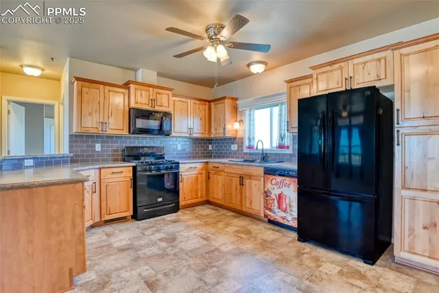 a kitchen with granite countertop a stove top oven microwave and cabinets