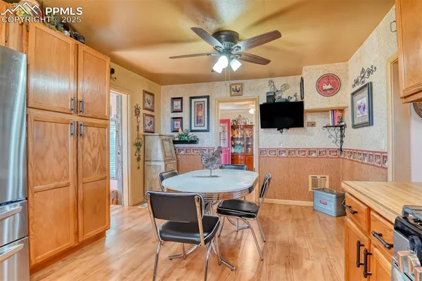 a view of a dining room with furniture a rug and wooden floor