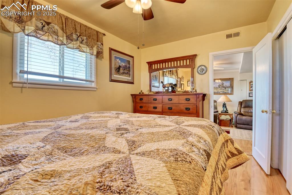 22500 Enoch Road Calhan, CO 80808 - Photo 10 of 50 a bed room with a bed mirror and a chandelier