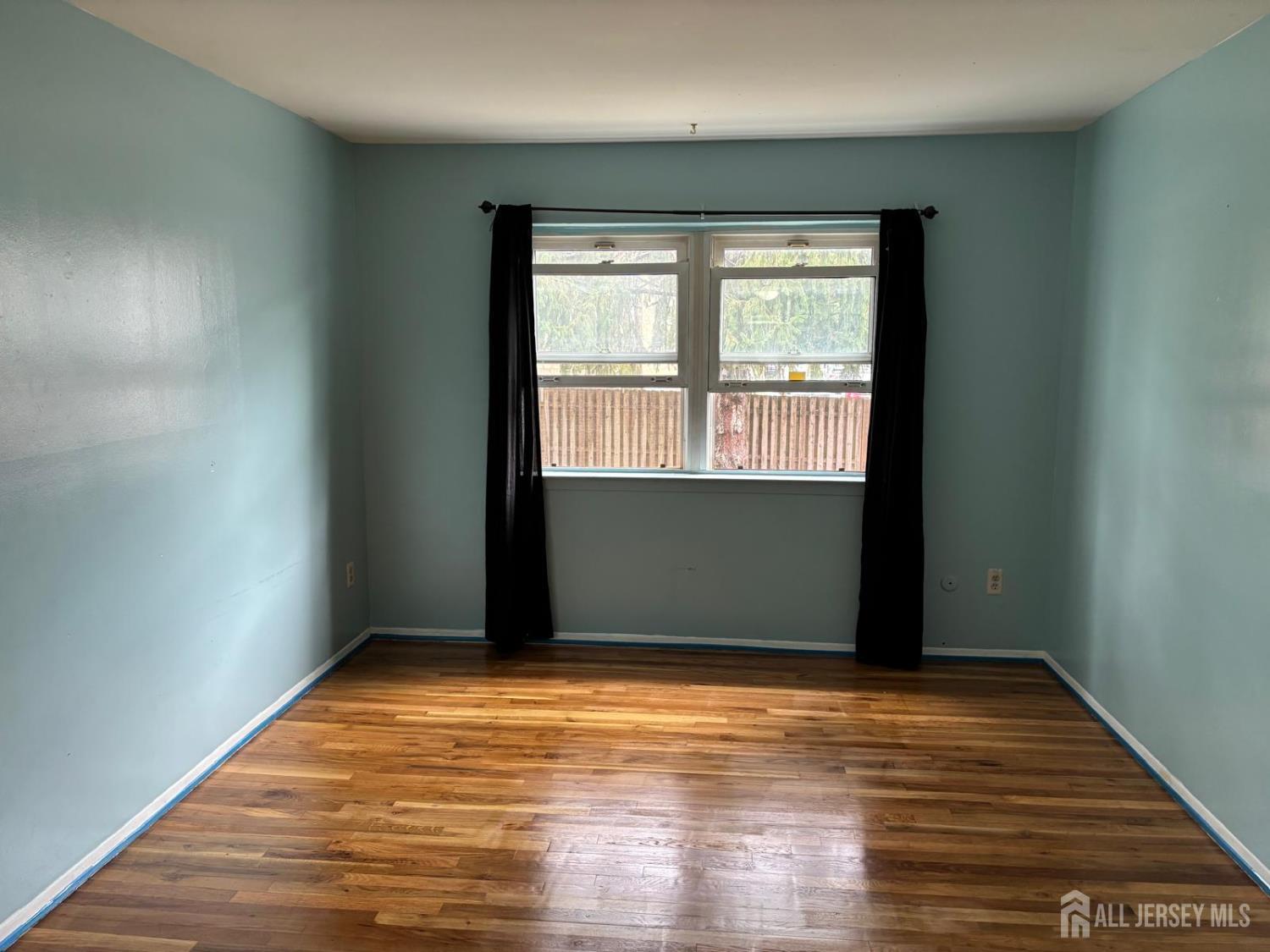 30 Judson Street, Unit 8A Edison, NJ 08837 - Photo 6 of 7 a view of an empty room with wooden floor and a window