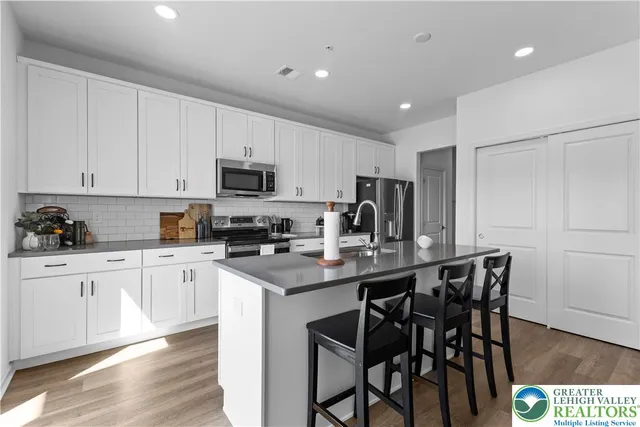 a kitchen with stainless steel appliances granite countertop a sink and stove