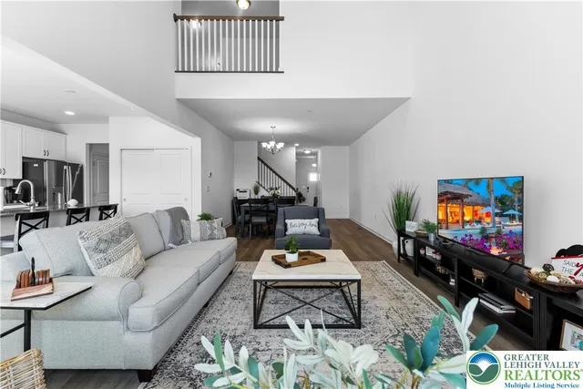 a living room with furniture and a view of kitchen