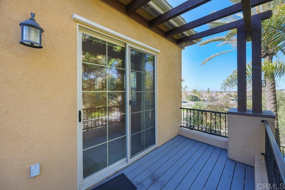 2204 Huntington Point Road, Unit 13 Chula Vista, CA 91914 - Photo 12 of 28 a view of a balcony with wooden floor and glass door