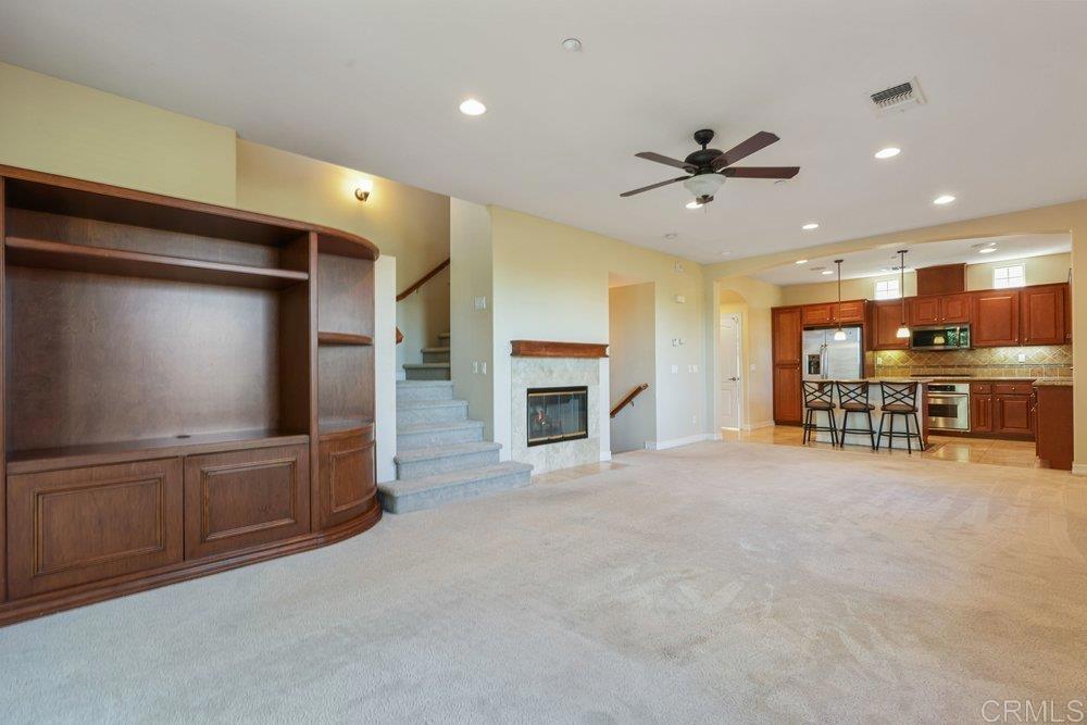 2204 Huntington Point Road, Unit 13 Chula Vista, CA 91914 - Photo 2 of 28 a living room with fireplace furniture and a flat screen tv
